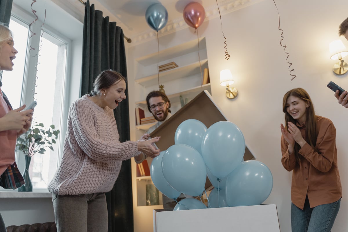 A Pregnant Woman Excitedly Looking at the Blue Balloons during the Gender Reveal